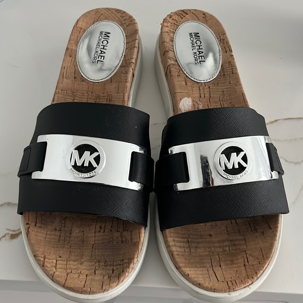 Micheal Kors Slides, size 81/2 black with white trim on the slight wedge
